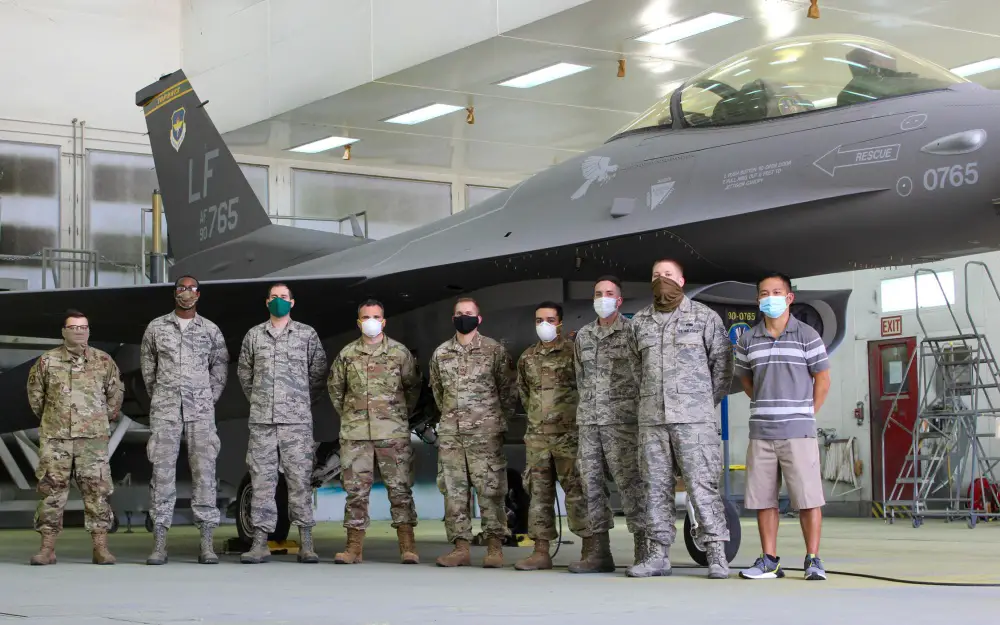A team of nine 56th Equipment Maintenance Squadron Low Observable Aircraft Structural Maintenance personnel pose for a photo June 27, 2020, at Luke Air Force Base, Ariz. 