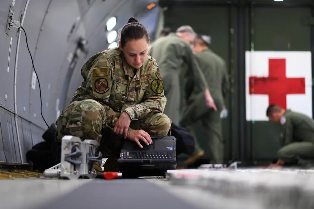 Tech. Sgt. Leah Oakleaf, 931st Aircraft Maintenance Squadron crew chief assigned to McConnell Air Force Base, Kansas reviews her technical order for configuration plans of the fuselage cargo palette locks. 