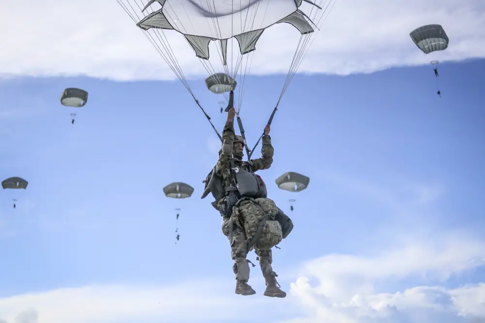 Paratroopers from the 4th Brigade Combat Team (Airborne), 25th Infantry Division, jump from a C-17 onto Andersen Air Force Base Guam on June 30.