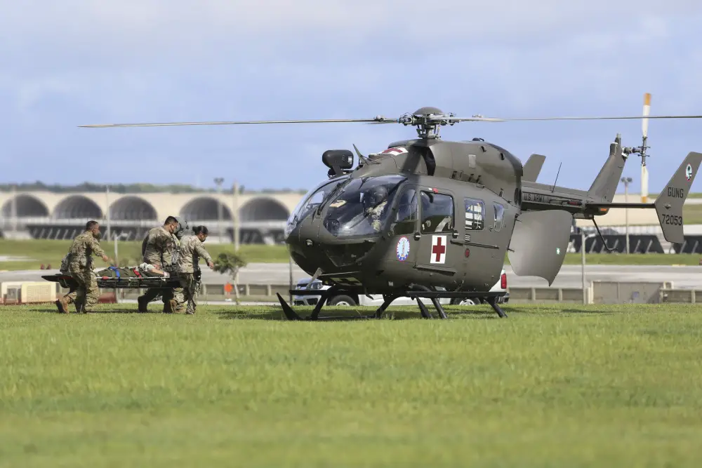 Soldiers from the Guam National Guard load a medical evacuation patient into a GUNG Lakota helicopter at Andersen Air Force Base on June 30.