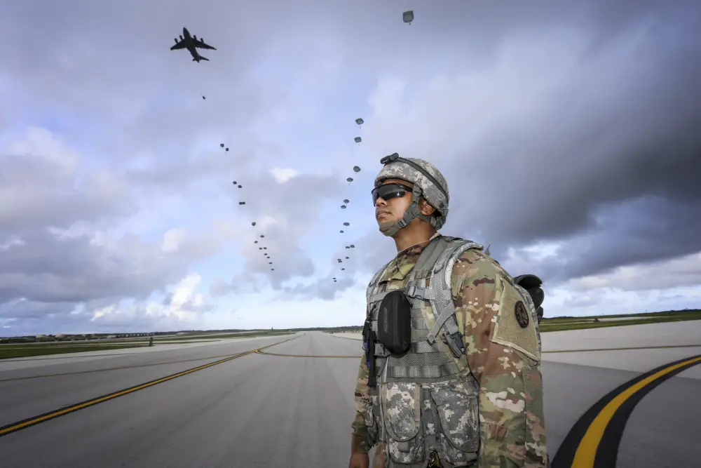 Pfc. Daron Foster of the Guam National Guard's 1-294th Infantry Regiment, awaits the arrival of over 400 paratroopers from the 4th Brigade Combat Team (Airborne), 25th Infantry Division on Andersen Air Force Base Guam on June 30.
