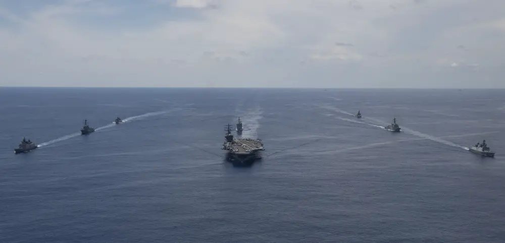 The Nimitz Carrier Strike Group, consisting of flagship USS Nimitz (CVN 68), Ticonderoga-class guided missile cruiser USS Princeton (CG 59), and Arleigh Burke-class guided missile destroyers USS Sterett (DDG 104) and USS Ralph Johnson (DDG 114), along with Indian Navy ships Rana, Sahyadri, Shivalik and Kamorta, steam in formation during a cooperative deployment in the Indian Ocean July 20.