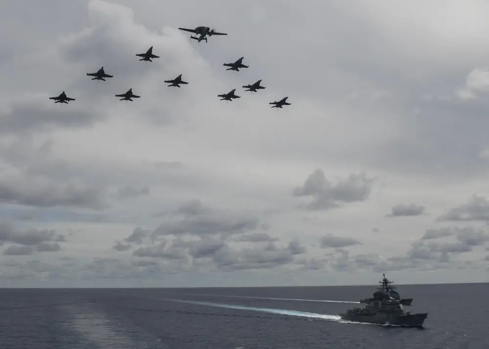 Aircraft from Carrier Air Wing 5 and Carrier Air Wing 17 fly in formation over the USS Nimitz (CVN 68) and USS Ronald Reagan (CVN 76) Carrier Strike Groups.