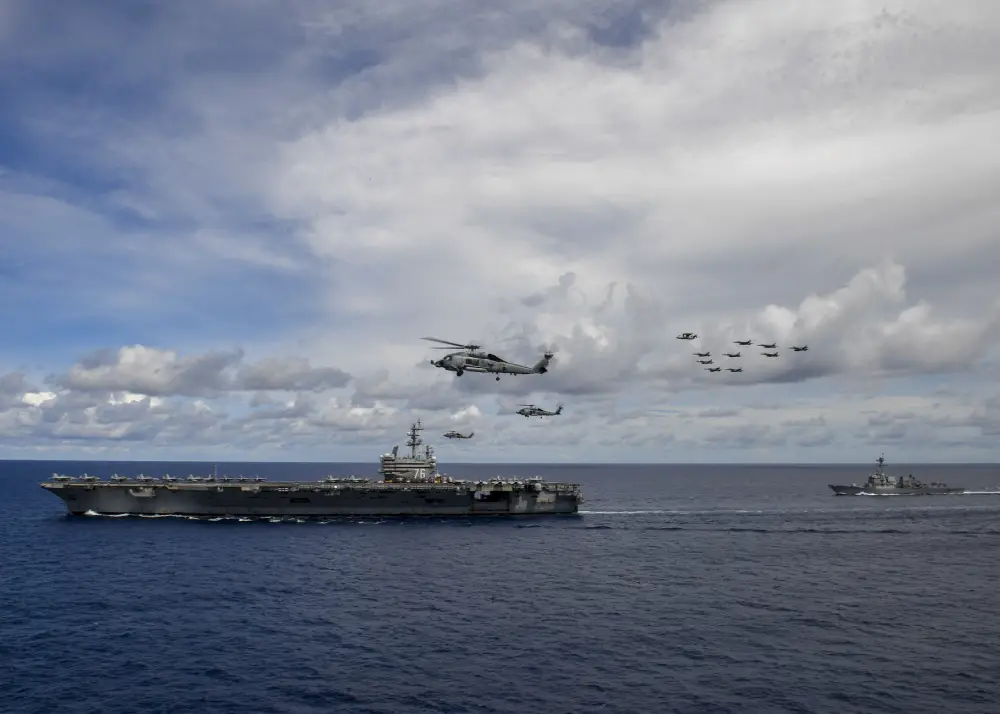 Aircraft from Carrier Air Wing 5 and Carrier Air Wing 17 fly in formation over the Nimitz Carrier Strike Force (CSF). 