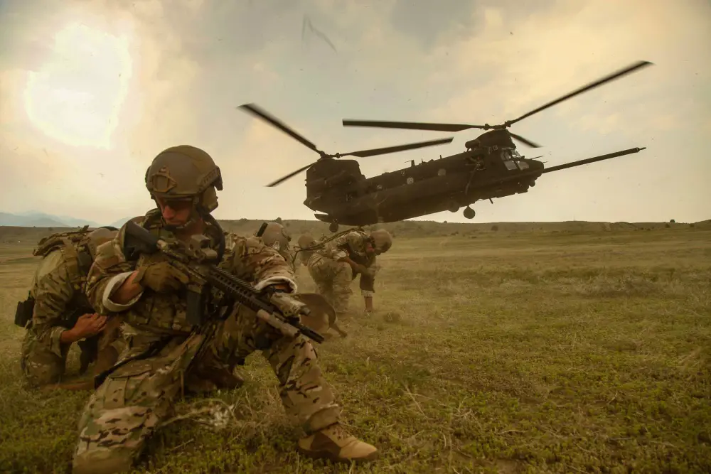 U.S. Army Soldiers, assigned to 10th Special Forces Group (Airborne), prepare to load onto an MH-47 Chinook helicopter during pre deployment training on Fort Carson, CO.