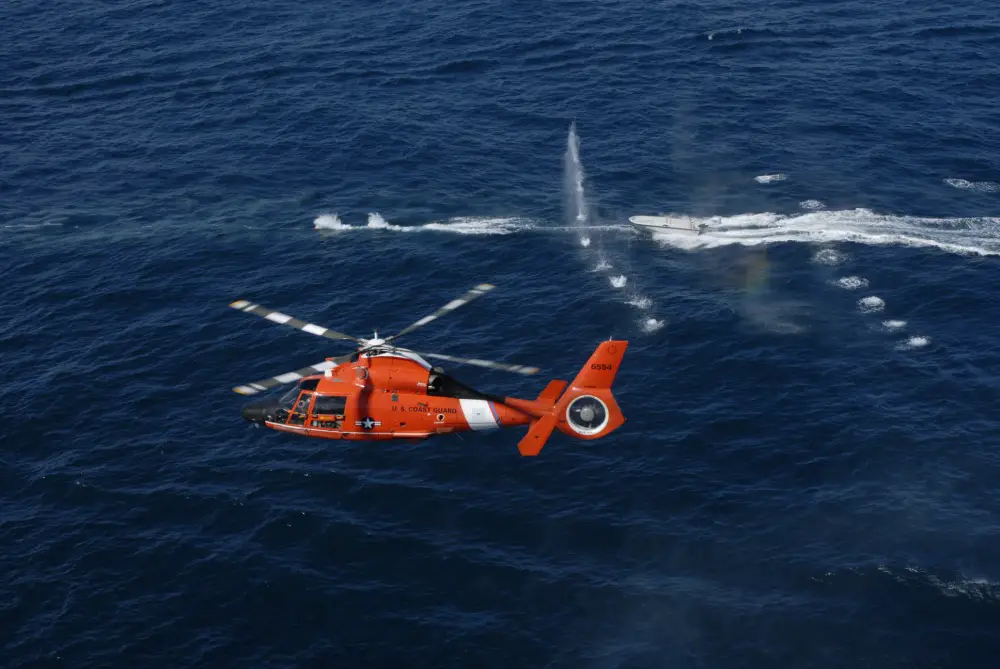 A helicopter crew from the Helicopter Interdiction Tactical Squadron Jacksonville trains off the coast of Jacksonville. This is a demonstration of warning shots fired at a non-compliant boat.