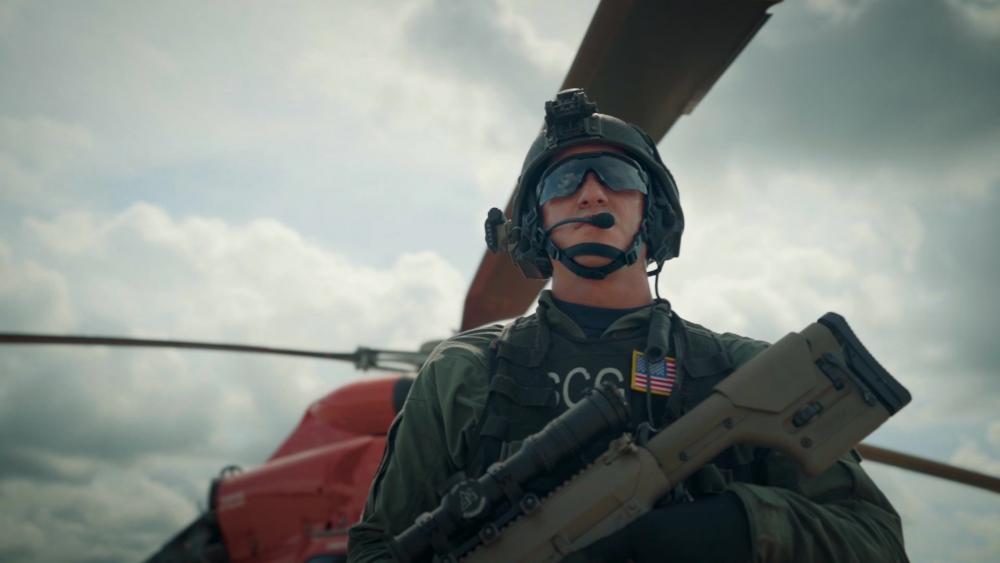 Coast Guard Petty Officer Brett Patterson, crewmember of Helicopter Interdiction Tactical Squadron (HITRON), Jacksosonville, Fla., mans an M-240 machine gun on board a Stingray MH-68A helicopter.