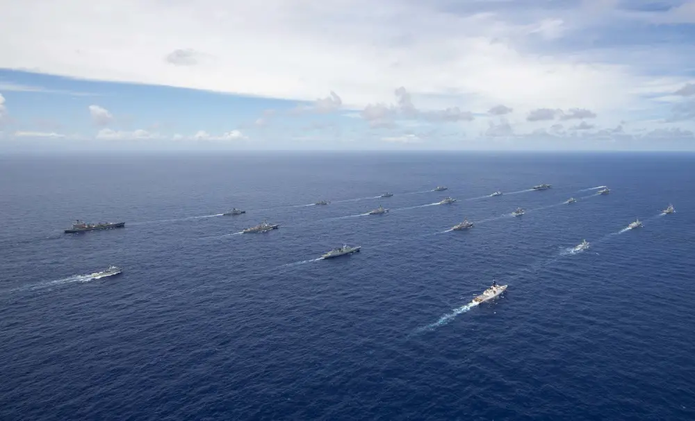 Multinational navy ships and a submarine steam in formation during a group sail off the coast of Hawaii during Exercise Rim of the Pacific (RIMPAC) 2020, August 21.