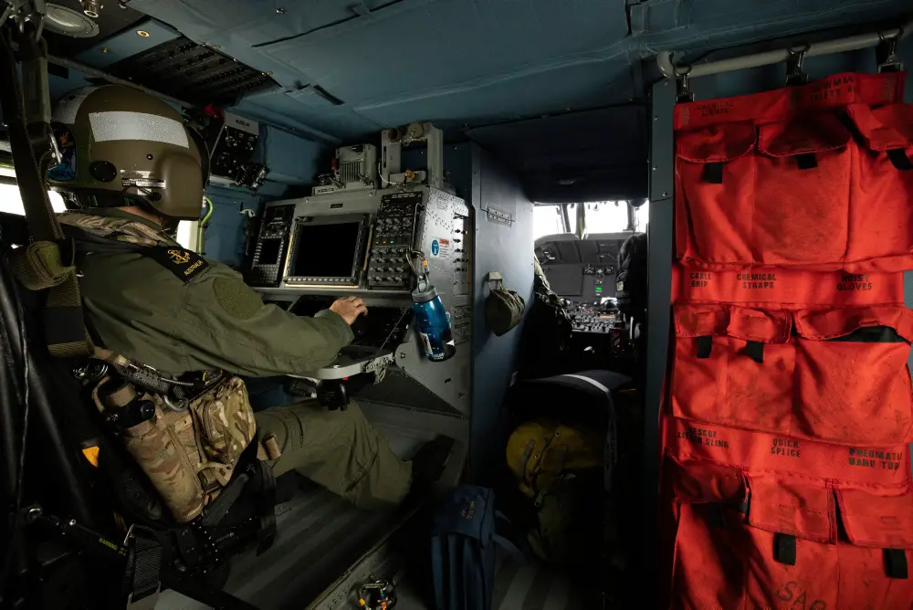 Royal Australian Navy sailor, Leading Seaman Aircrewman Dylan Skipsey operates the MH-60R Seahawk console in the rear of the aircraft during a photography exercise on the 18th September 2019.