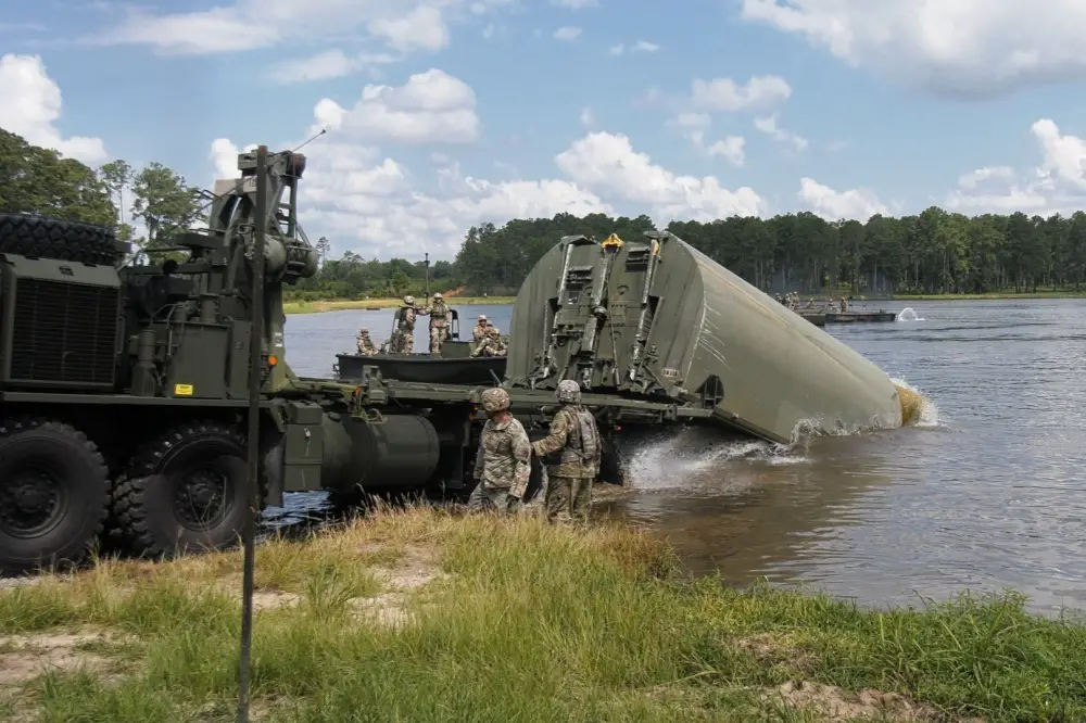 Senior leaders from XVIII Airborne Corps observe after assisting Soldiers from the 361st Multi-Role Bridge Company, 841st Engineer Battalion, 926th Engineer Brigade, launch an interior bay, improved ribbon bridge, July 17, 2020, at Pineview Lake, Fort Stewart, Georgia.