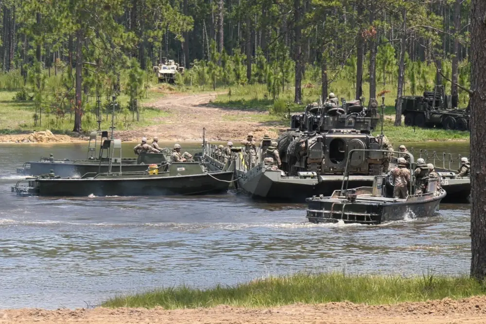 Soldiers from the 926th Engineer Brigade move two M2 Bradley Fighting Vehicles across Pineview Lake on a ribbon raft, July 17, 2020, at Fort Stewart, Georgia. 