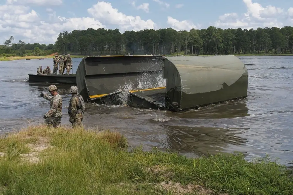 Senior leaders from XVIII Airborne Corps observe after assisting Soldiers from the 361st Multi-Role Bridge Company, 841st Engineer Battalion, 926th Engineer Brigade, launch an interior bay, improved ribbon bridge, July 17, 2020, at Pineview Lake, Fort Stewart, Georgia. 