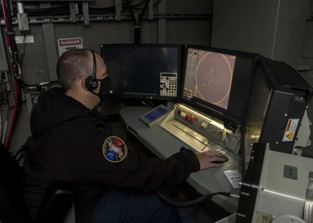 Operations Specialist 1st Class David Geary, from Davenport, Iowa, an air intercept controller, assigned to USS Gerald R. Ford's (CVN 78) operations department, stands watch at a console inside the ships Combat Direction Center July 30, 2020 during an Aircraft Intercept Control exercise
