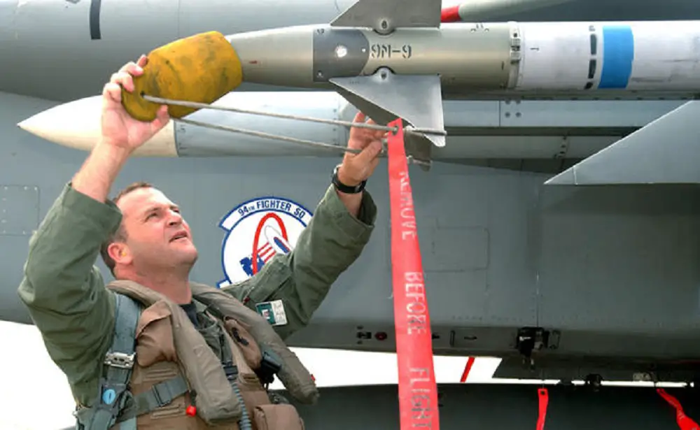 AIM-9M Sidewinder with distinctive "Dash-9" lettering being preflighted by a USAF pilot. The blue stripe indicates that this example has an inert warhead intended for training purposes