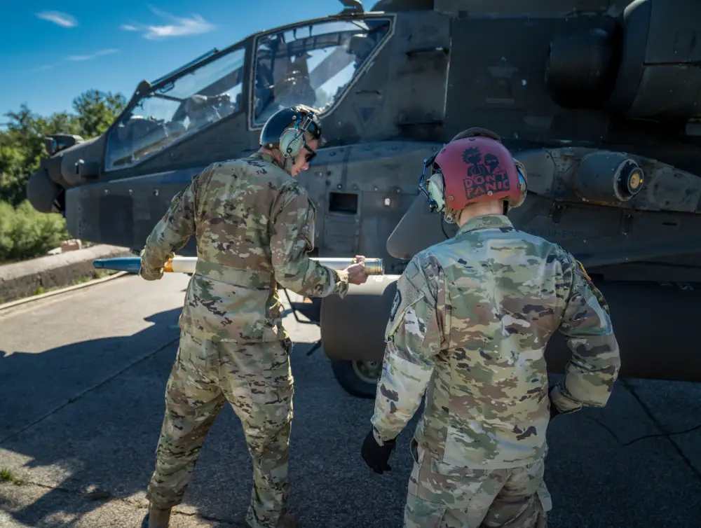 U.S. Army Spc. Jonathan Castrechino and Spc. Sean Seksinsky load rockets into an AH-64 Apache from A Co, 1-3 Attack Reconnaissance Battalion on Sep. 8 at Baumholder Training Area, Germany. 
