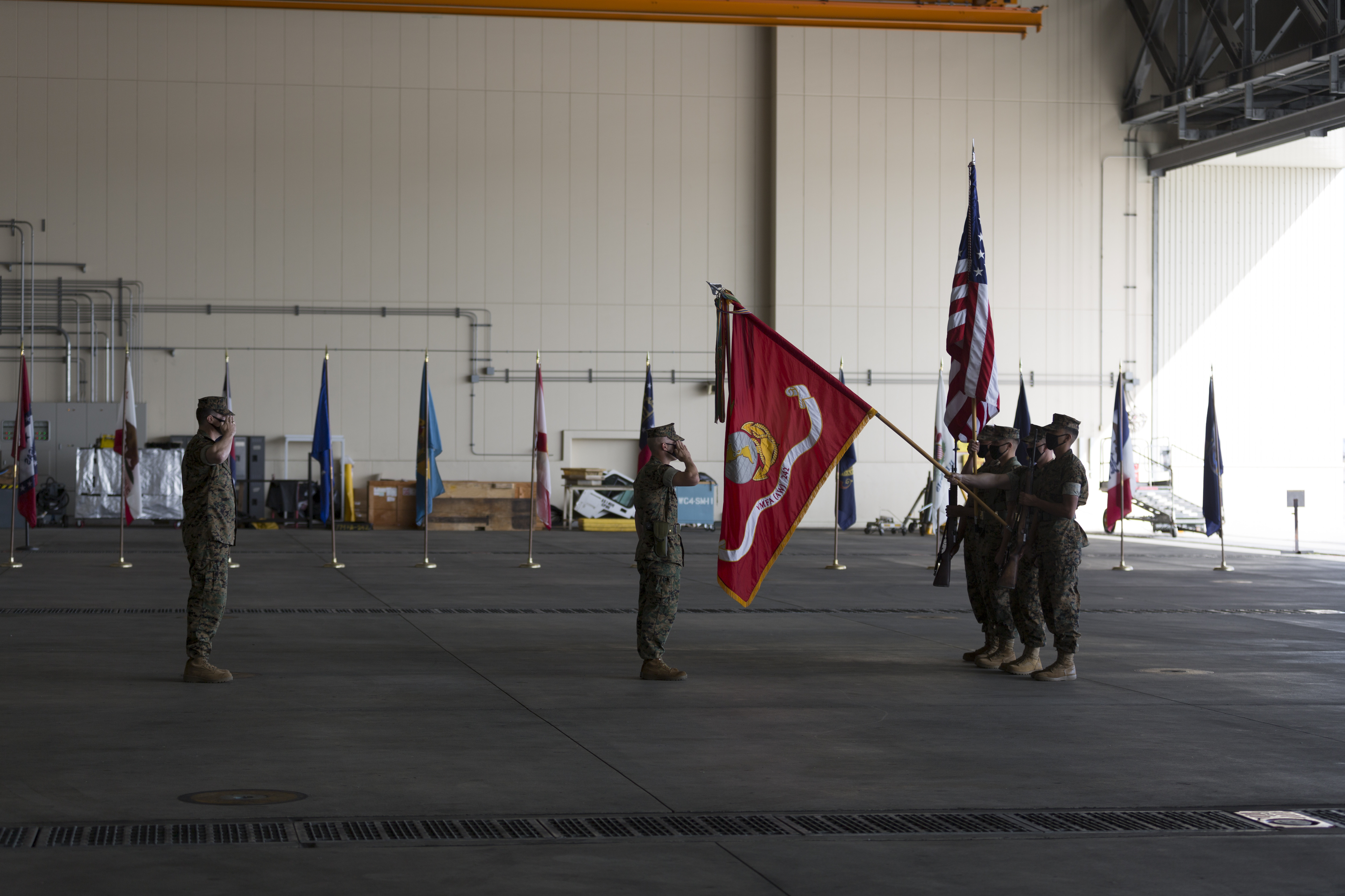 U.S. Marines with Marine All Weather Fighter Attack Squadron (VMFA(AW)) 242 present colors during the change of command and re-designation of VMFA(AW)-242 at Marine Corps Air Station Iwakuni, Japan, Oct. 16, 2020. U.S. Marine Corps Lt. Col. Andrew Kelemen, outgoing commanding officer of VMFA(AW)-242, relinquished command to Lt. Col. Michael Wyrsch during the re-designation and change of command of VMFA(AW)-242 to Marine Fighter Attack Squadron (VMFA) 242. VMFA-242's transition to the F-35B Lightning II brings advanced avionics capabilities to joint, allied, and partner forces in support of the U.S.-Japan Alliance and a free and open Indo-Pacific. (U.S. Marine Corps photo by Lance Cpl. Tyler Harmon)