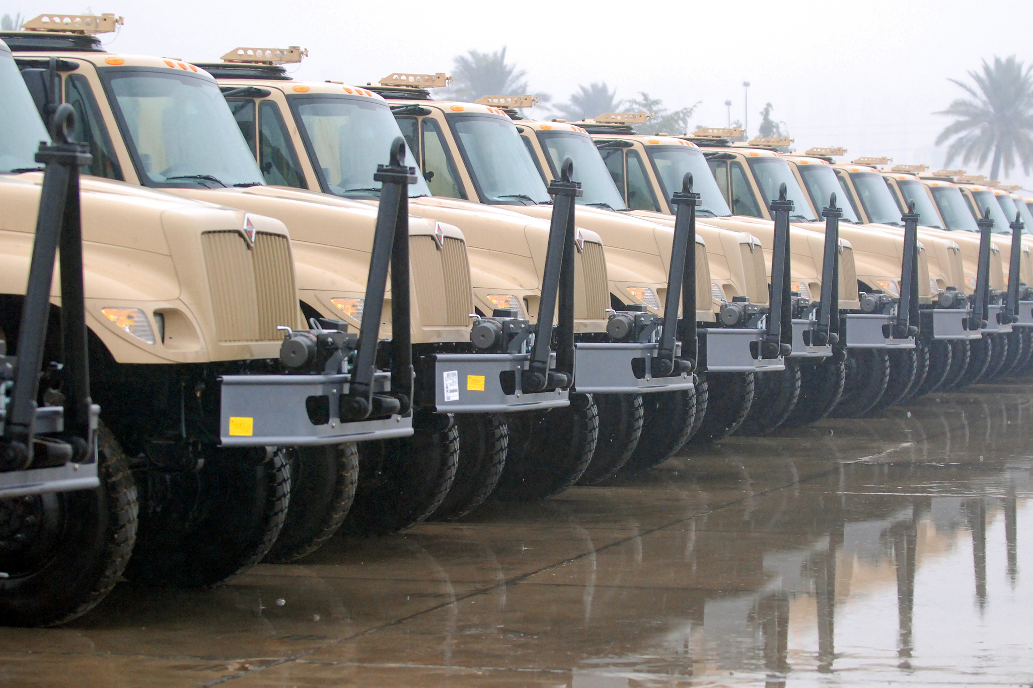  A portion of the 37 5-ton trucks delivered to the Iraqi Army Jan. 23 sit at Al Muthanna Vehicle Warehouse.