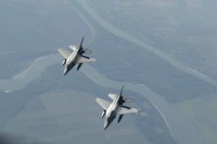 Two Romanian F-16 Fighting Falcons -- which have just been approved for upgrades by the U.S. State Department -- fly below a U.S. Air Force KC-135R Stratotanker above Bucharest, Romania
