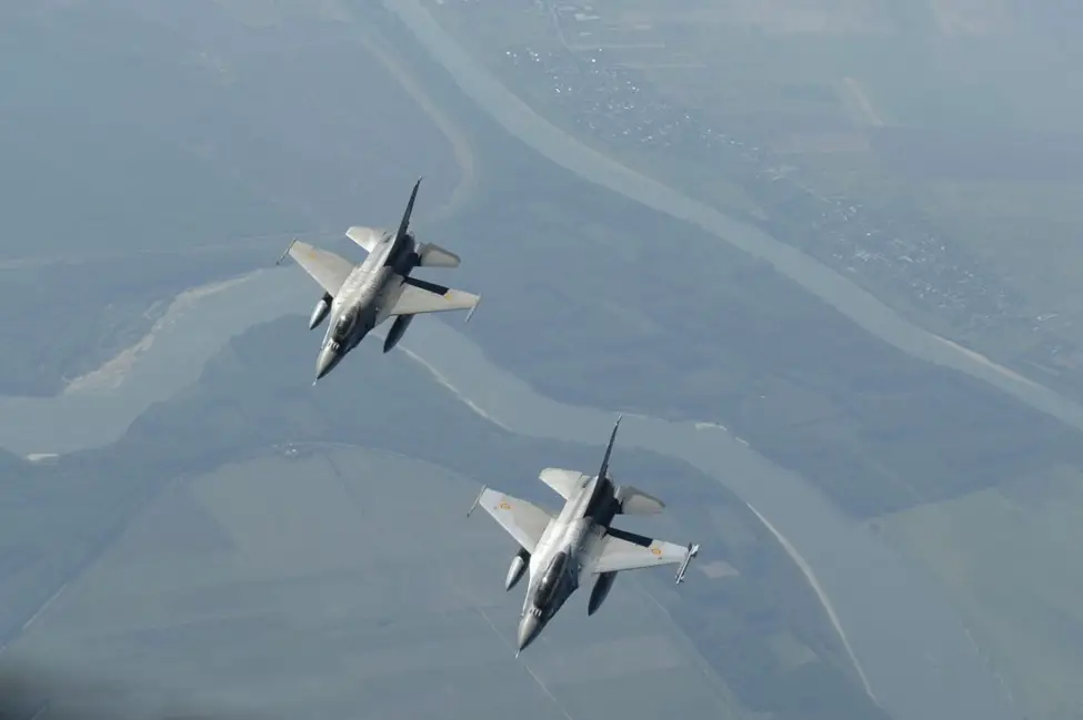 Two Romanian F-16 Fighting Falcons -- which have just been approved for upgrades by the U.S. State Department -- fly below a U.S. Air Force KC-135R Stratotanker above Bucharest, Romania