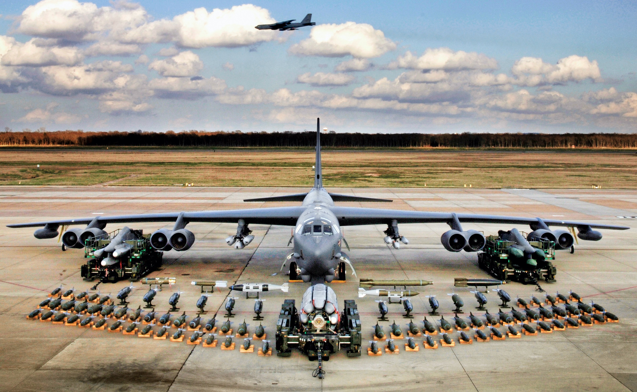 Boeing B-52H static display with weapons, Barksdale AFB 2006. A second B-52H can be seen in flight in the background