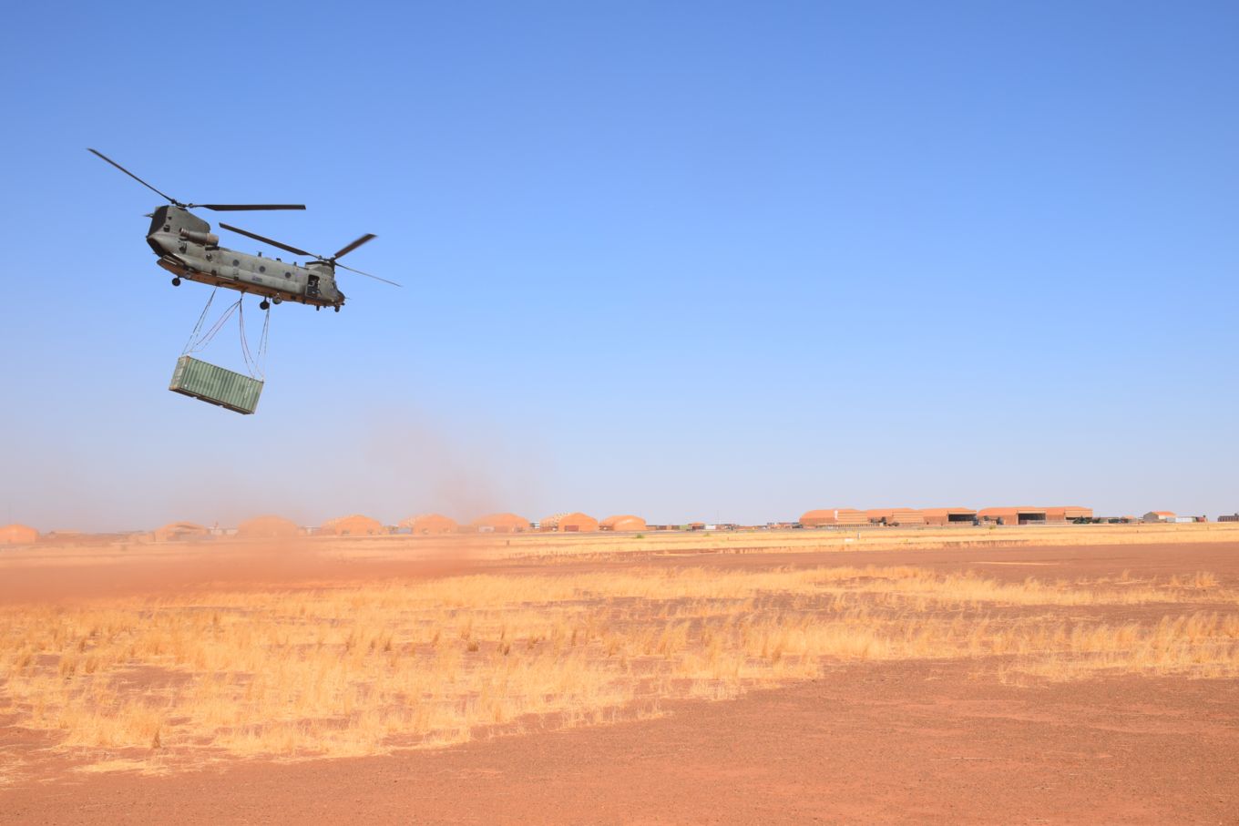 An RAF Chinook and 3 Joint Helicopter An RAF Chinook and 3 Joint Helicopter Support Squadron Personnel lifts a heavy ISO container in order to assist with French Op BARKHANE, Camp Roberts, Gao, Mali.