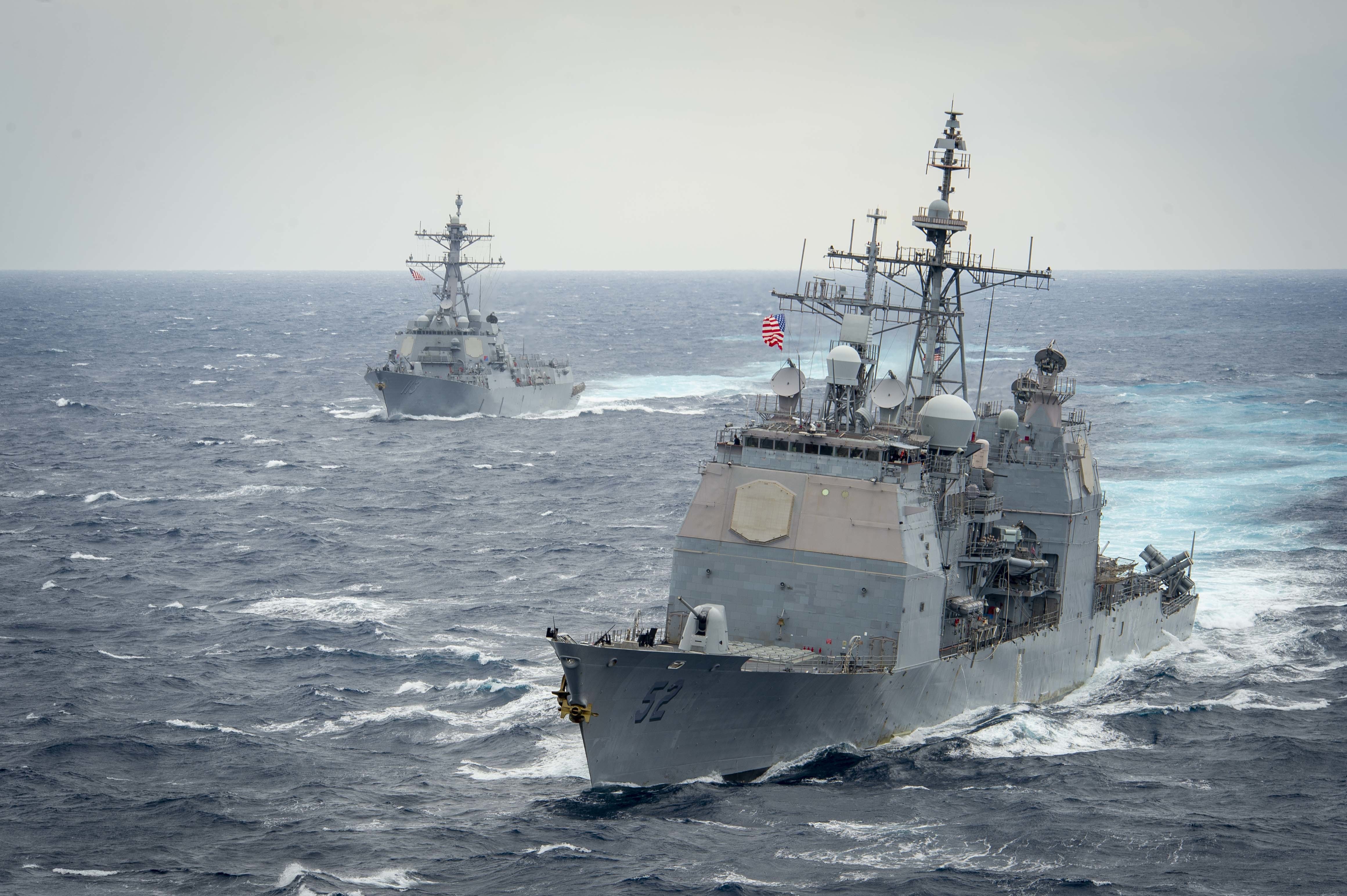 The Ticonderoga-class guided-missile cruiser USS Bunker Hill (CG 52), front, and the Arleigh Burke-class guided-missile destroyer USS John Finn (DDG 113) transit the Pacific Ocean.