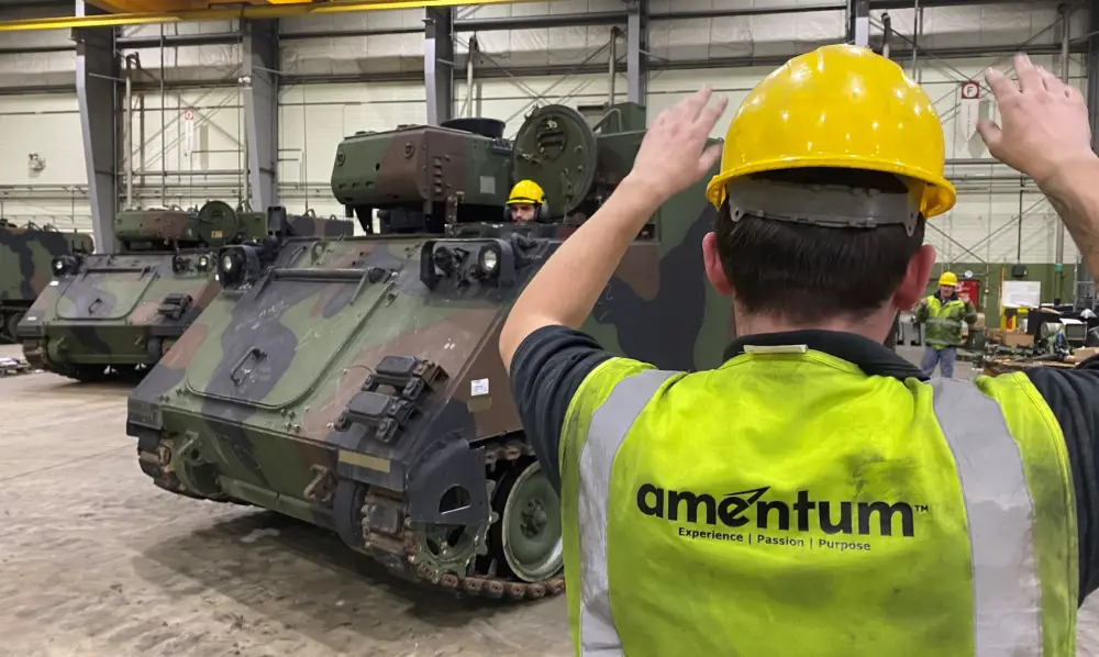 A contractor ground guides an armored personnel carrier inside one of the hangars at Coleman worksite. The 405th Army Field Support Brigade's Army Field Support Battalion-Mannheim is responsible for two Army Prepositioned Stock-2 sites. The one at Coleman Barracks houses an Armored Brigade Combat Team's worth of vehicles and equipment â€“ forward â€“ and ready to issue.