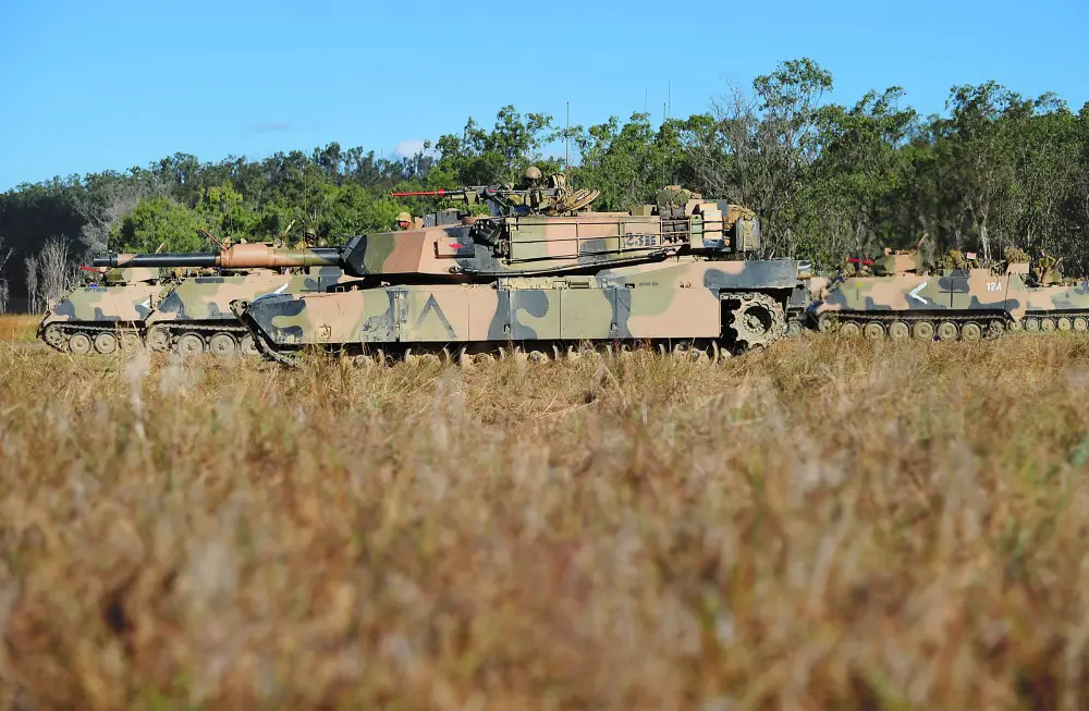 An M1A1 Abrams tank and M113AS4 armored fighting vehicles from the Adelaide-based 7th Battalion, Royal Australian Regiment, prepare to deploy with the Battle Group during Exercise Predator's Strike.