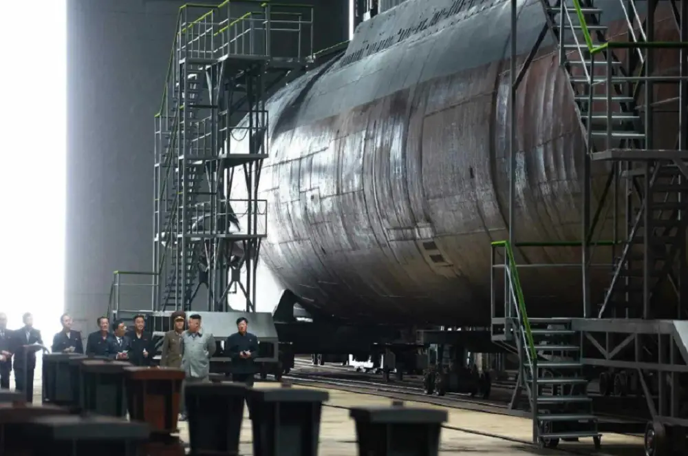 This photo, released by the Korean Central News Agency on July 23, 2019, shows North Korean leader Kim Jong-un (2nd from R) inspecting a newly built submarine.