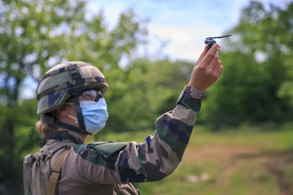 A French Marine artillerywoman performs a Black Hornet 3, a military micro unmanned aerial vehicle, demonstration for U.S. Marine Corps Maj. Gen. Francis Donovan, commanding general of 2d Marine Division, on Military Camp of Canjuers, France, June 1, 2021.