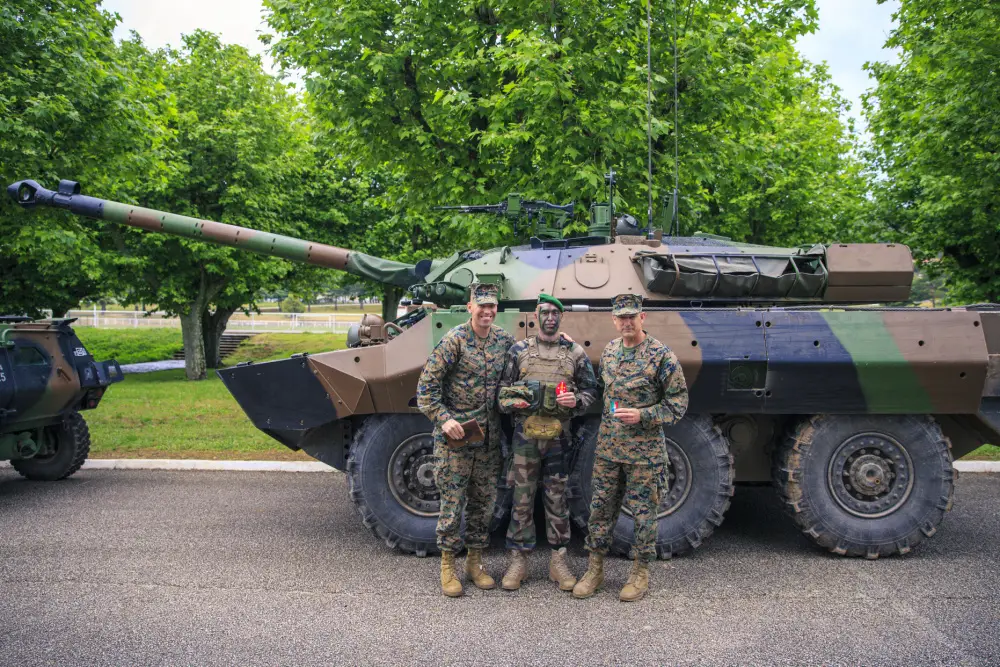 U.S. Marine Corps Maj. Gen. Francis Donovan, commanding general, 2d Marine Division (2d MARDIV), and Sgt. Maj. Daniel Krause, sergeant major of 2d MARDIV, pose for a photo with a French soldier with the 1st Foreign Legion Cavalry Regiment.
