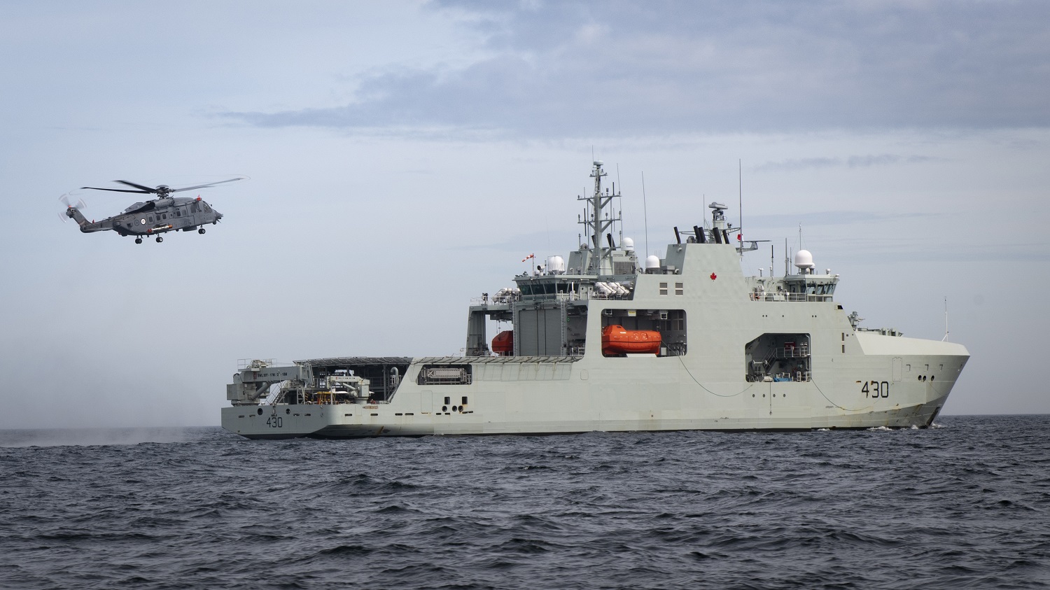 CH148819 Cyclone from 12 Wing Shearwater flies off the stern of HMCS HARRY DEWOLF during Phase 4 Shipboard Helicopter Operating Limits off the coast of Nova Scotia on June 3, 2021.