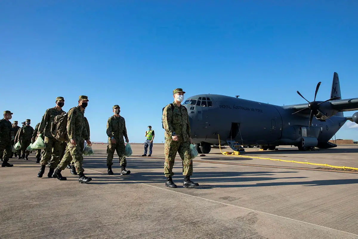 Soldiers from the Japan Ground Self-Defense Force make their way to the terminal from a Royal Australian Airforce C-130J Hercules after landing at RAAF Base Darwin, NT.