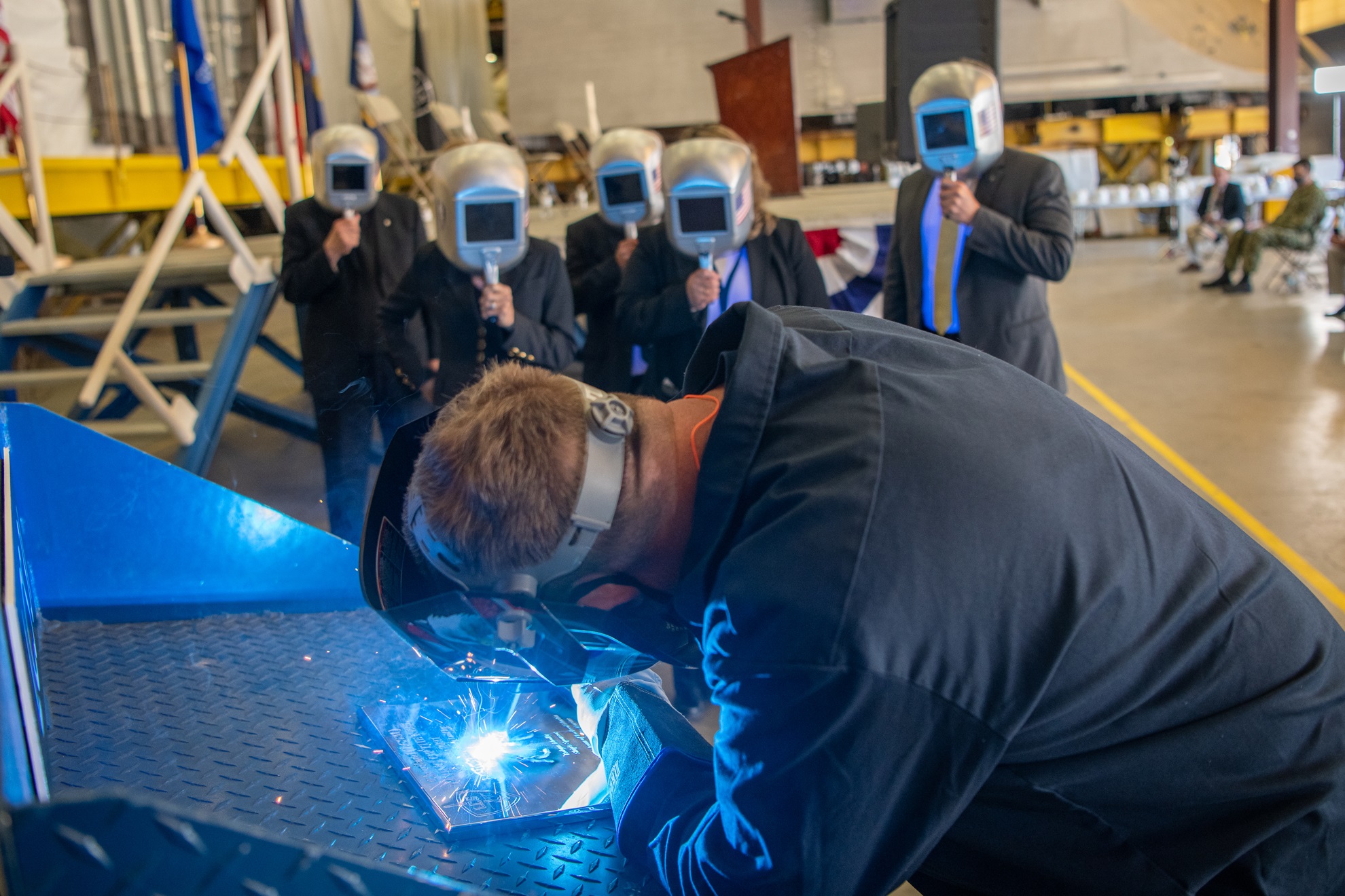 A welder authenticates the keel of Littoral Combat Ship (LCS) 31, the future USS Cleveland, by welding the initials of the ship's sponsor, Robyn Modly, wife of a Clevelander and former U.S. Navy Secretary, who has embraced the city as her own.