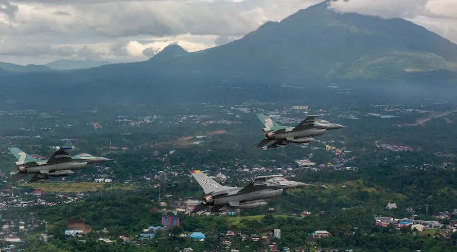  A U.S. Air Force F-16 Fighting Falcon fighter pilot flies alongside two Indonesian air force F-16 Fighting Falcon fighter pilots off the coast of Manado, Indonesia, during Cope West 19, June 20, 2019.