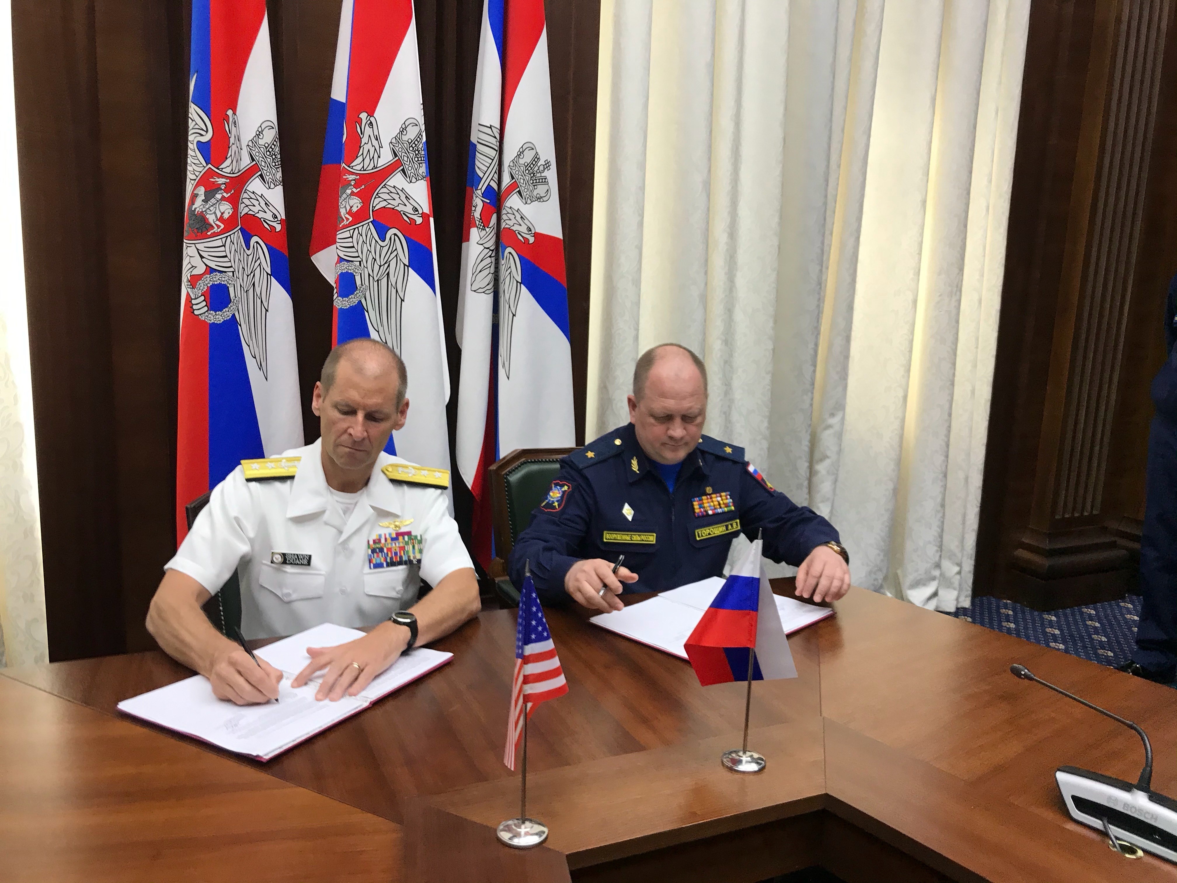  Rear Adm. Shawn Duane, left, head of the U.S. delegation, shakes hands with his Russian counterpart after signing the Prevention of Incidents On and Over the Waters Outside the Limits of the Territorial Sea (INCSEA) agreement in Moscow, May 25, 2021. 