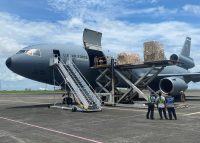 U.S. Air Force personnel unload weapons and equipment off a KC-10 Extender at Clark Air Base.