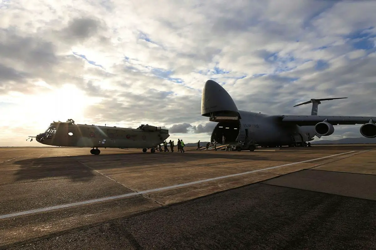 A new CH-47F Chinook heavy-lift helicopter is unloaded from a United Stated C-5 Galaxy at RAAF Base Townsville, Queensland.