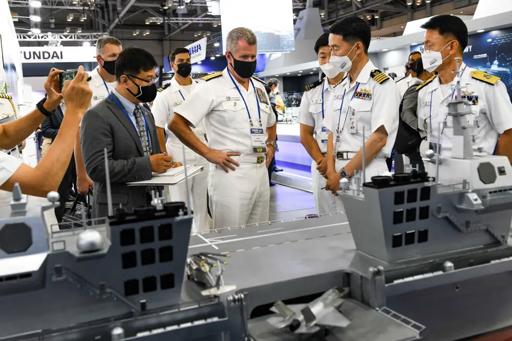 Adm. Samuel Paparo, Commander, U.S. Pacific Fleet, receives a brief about the Republic of Korea Navy's future light aircraft carrier program during a tour of the International Maritime Defense Industry Exhibition in Busan, Republic of Korea.