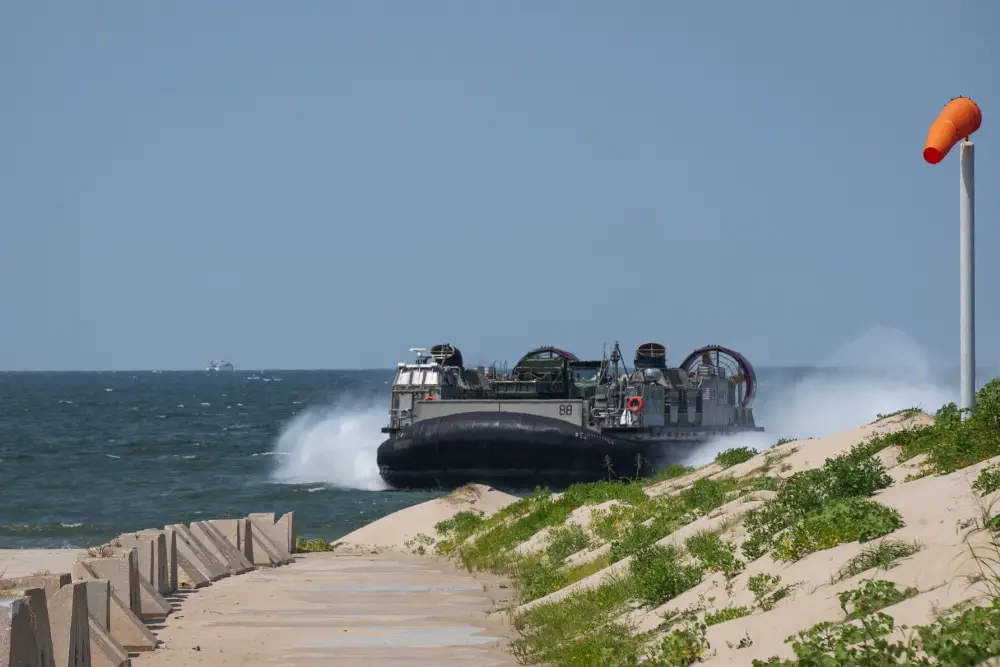 A U.S. Navy landing craft, air cushion lands on a beach while carrying tactical vehicles during Defense Support of Civil Authorities (DSCA) mission rehearsals at Naval Base Norfolk, Virginia, July 22, 2021. 