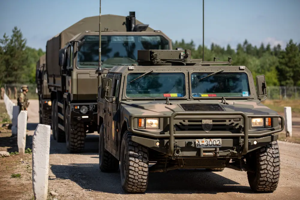 Romanian Land Forces vehicles, the URO VAMTAC (front) and Iveco Military Truck (back) depart for deployment readiness exercise "Rifle Ready" at Bemowo Piskie Training Area, Poland, July 1, 2021.