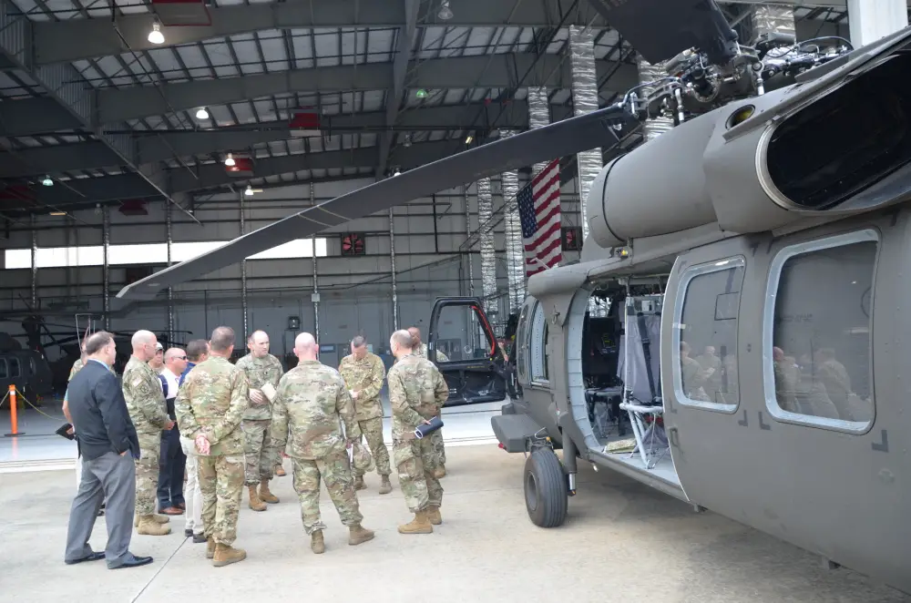 Lt. Col. Dan Thetford, center, Product Manager for the UH-60V Black Helicopter, discusses the aircraft capabilities with several State Aviation Officers at the Huntsville, Al. International Airport July 13.