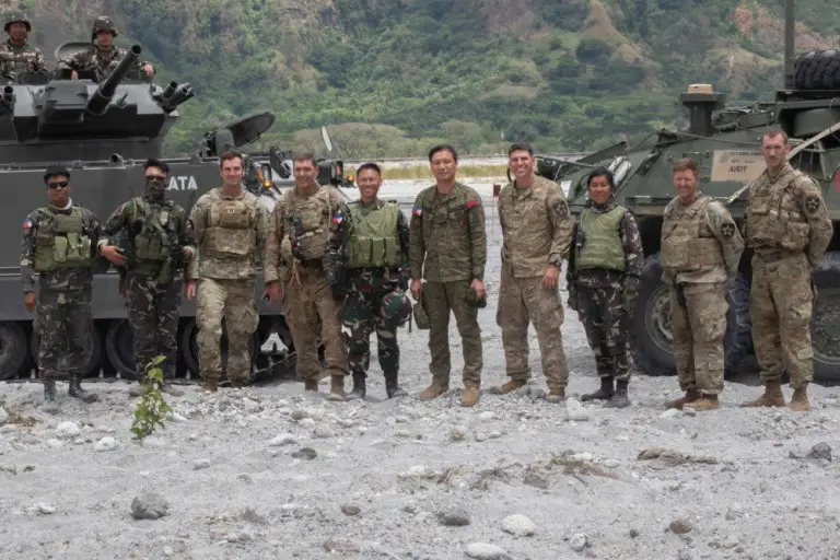 U.S. and Philippine Army soldiers pose for a photo after the commencement of the Combined Arms Live Fire Exercise at Colonel Ernesto Ravina Air Base, Philippines during Exercise Balikatan