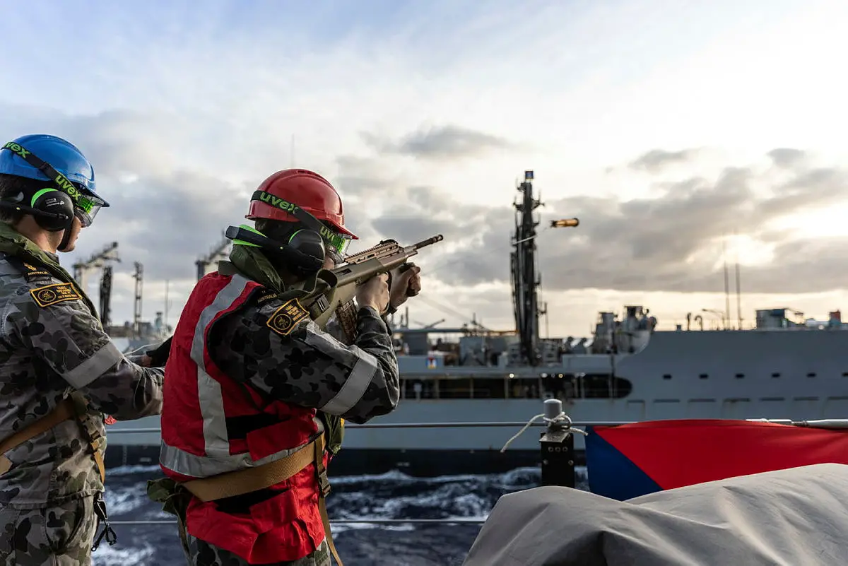 Able Seaman Boatswain’s Mate Jacob Hodge (right) fires the line-throwing projectile during a Replenishment at Sea with USNS Rappahannock, off the coast of Queensland as part of Exercise Talisman Sabre 2021.