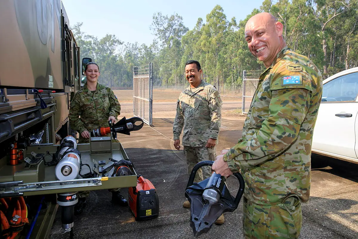 Aircraftwoman Amber Herz, US Army soldier Tech Sergeant Erik Montes and Leading Aircraftman Mitchell Houghton with rescue equipment from a Striker fire truck at RAAF Base Scherger, Queensland, during Exercise Talisman Sabre 2021.