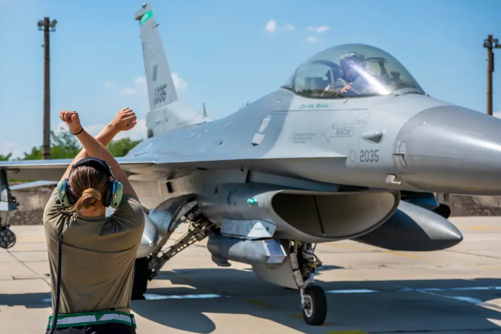 Senior Airman Brooke Parks, 555th Aircraft Maintenance Unit F-16 Fighting Falcon crew chief, marshalls a U.S. Air Force F-16 at Graf Ignatievo Air Base, Bulgaria, July 9, 2021.