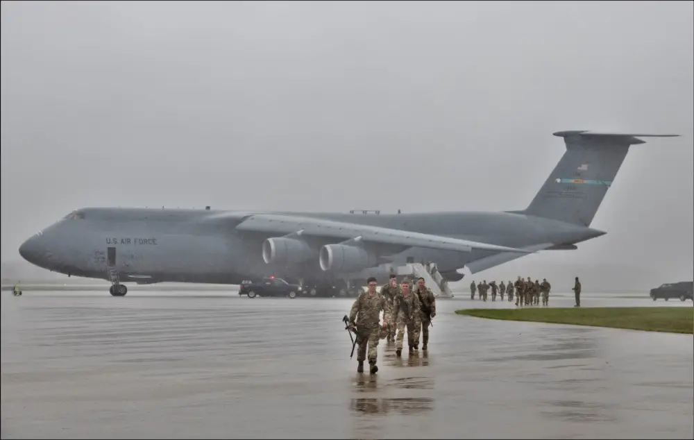 An Air Force C-5M Super Galaxy and aircrew from Dover Air Force Base, Del., carrying Soldiers with the 3rd Brigade Combat Team, 10th Mountain Division of Fort Polk, La., parks on a parking ramp July 7, 2021, as part of an Emergency Deployment Readiness Exercise (EDRE) at Volk Field, Wis. 