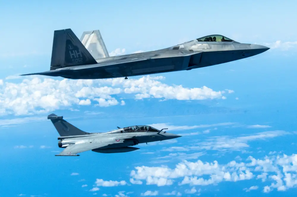 A Hawaii Air National Guard F-22 Raptor flies in formation with a French Air and Space Force F3-R Rafale June 30, 2021, near Oahu, Hawaii. 