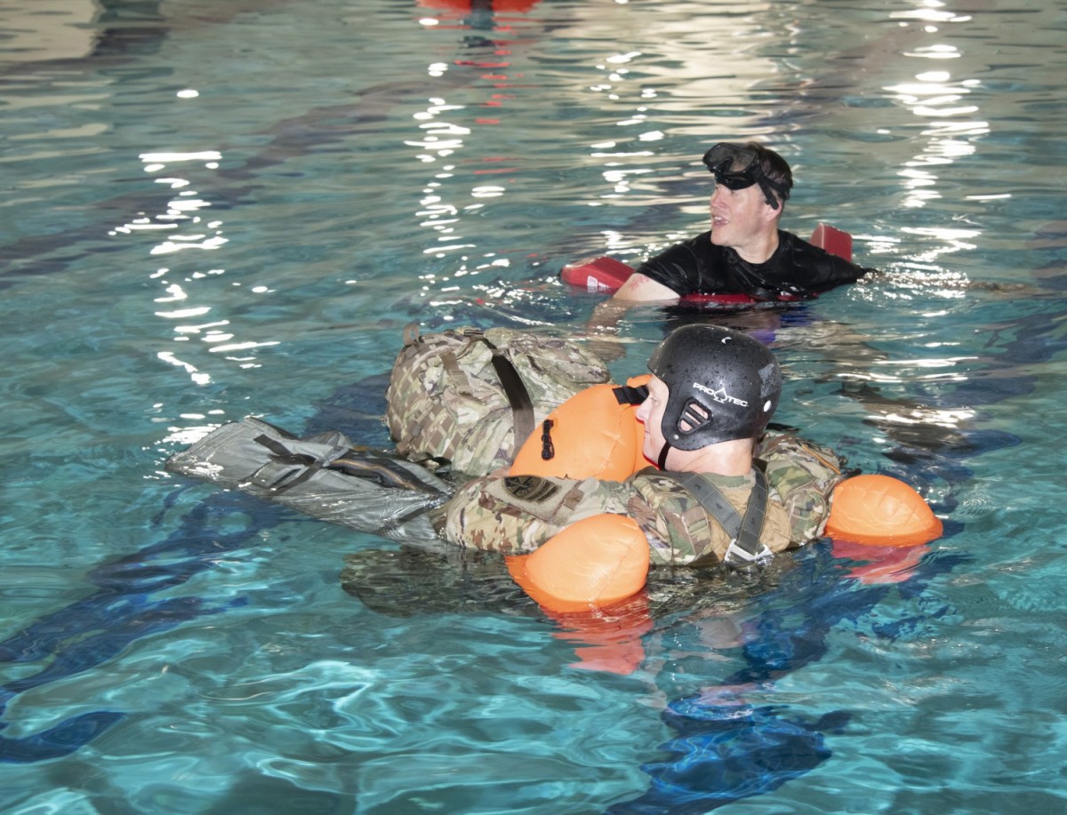 An Airborne and Special Operations Test Directorate test jumper conducts a combat equipment buoyancy test during the early stages of Parachutist Flotation Device (PFD) testing.