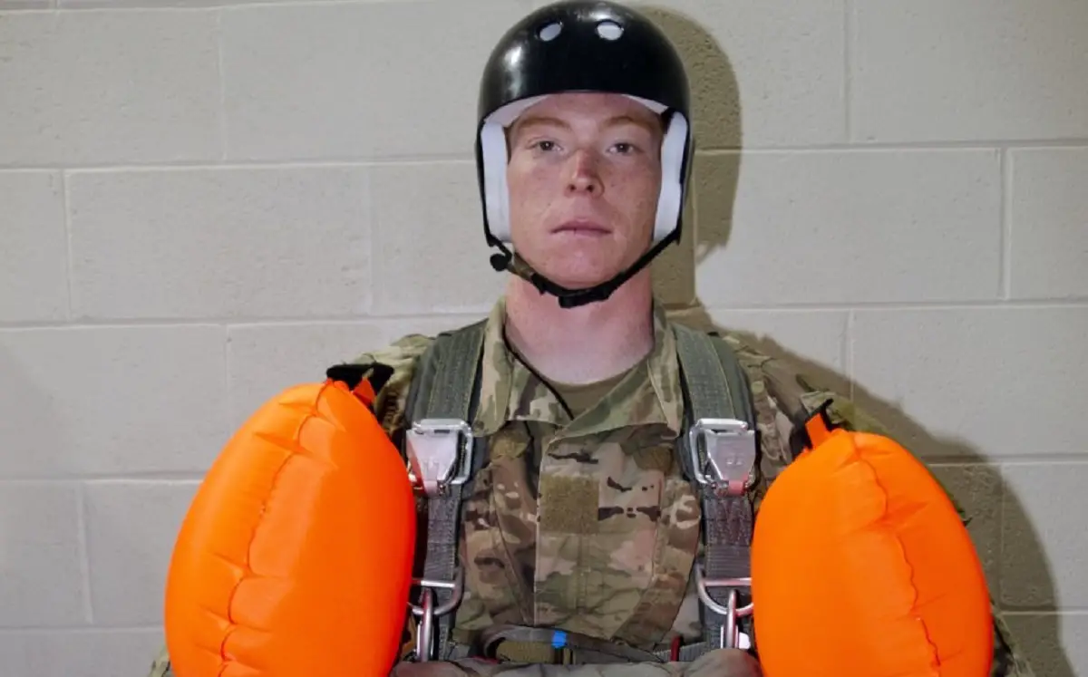 An Airborne and Special Operations Test Directorate soldier prepares to enter the water prior to the start of Parachutist Flotation Device (PFD) pool testing. 